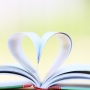 Open book with pages folded into a heart